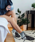 Person wearing Death Scythe Themed Ankle And Crew Socks 5 Pack Non Slip Breathable Athletic Socks in cozy living room setting