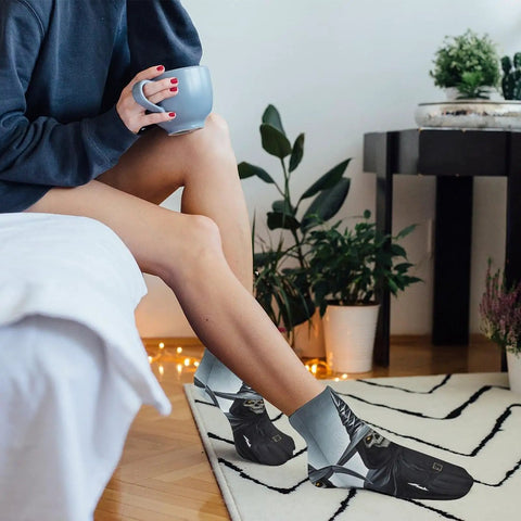 Person wearing Death Scythe Themed Ankle And Crew Socks 5 Pack Non Slip Breathable Athletic Socks in cozy living room setting