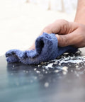 Close-up of a hand using Heavy Duty Recycled Color Terry Cloth Cleaning Rags For Garage And Shop to clean a surface.