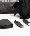 Must Have All In One Military Survival Sewing Kit Portable Repair Set With Needles Thread Scissors Buttons And Tools In Durable Zipper Nylon Case next to a black flashlight, knife, and bag on a table.