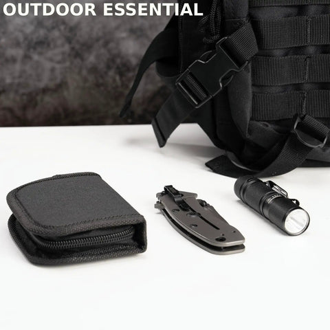 Must Have All In One Military Survival Sewing Kit Portable Repair Set With Needles Thread Scissors Buttons And Tools In Durable Zipper Nylon Case next to a black flashlight, knife, and bag on a table.