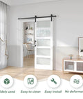 32 Inch By 84 Inch White Frosted Glass Sliding Barn Door With 66 Inch Hardware Kit And Handle installed in modern room