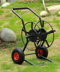 Totally Rock Solid Heavy Duty Garden Hose Reel Cart With Smooth Rolling Wheels on grass, featuring durable steel frame and red wheels.