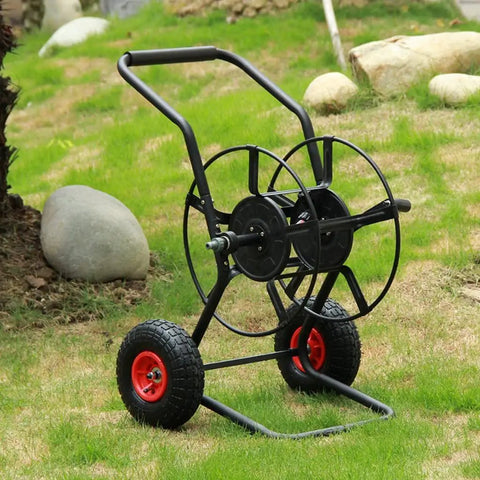 Totally Rock Solid Heavy Duty Garden Hose Reel Cart With Smooth Rolling Wheels on grass, featuring durable steel frame and red wheels.