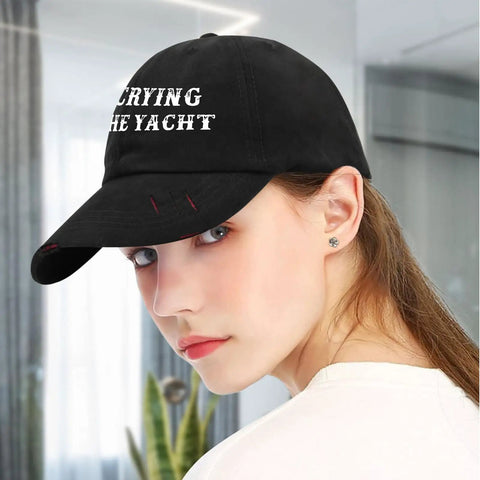 Woman wearing black 'Yacht Ready Sun Hat For Dad A Lightweight Colorful Cap With An Adjustable Strap Built For Outdoor Fun And Style This Versatile Beach Ready Gear Stays Comfortable All Day In A Variety Of Color Options' with white text on front, indoors.