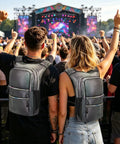 Couple wearing Glow In The Dark Hydration Pack With 3L Water Bladder at a festival, reflective design and insulated backpack.
