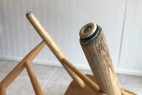 Heavy Duty 7/8 Inch Round Furniture Sliders Featuring Zero Friction Glide Tech For Slick Carpet And Wood Floor Moves While Shielding Surfaces From Scuffs Tan 8 Pack on wooden chair leg.