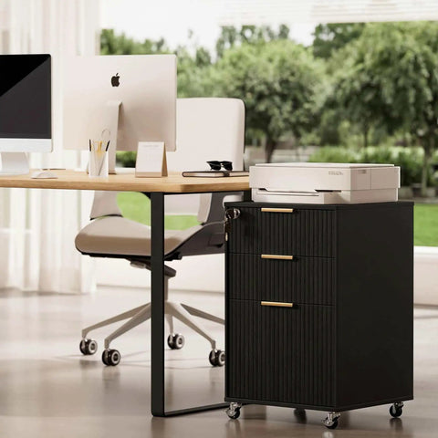 Slick Fluted 3 Drawer Rolling File Cabinet With Secure Lock, Heavy Duty Casters, Compact Printer Stand Table And Under Desk Wooden Storage Organizer For Home Office Workstation In Matte Black next to sleek desk and printer.