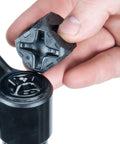 Hand holding Ultimate Suspension Fork Cap Removal Tool for Fox and RockShox Top Caps with Six Sided Design