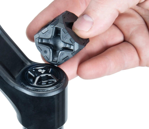 Hand holding Ultimate Suspension Fork Cap Removal Tool for Fox and RockShox Top Caps with Six Sided Design