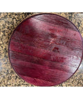 Top view of 12-inch handcrafted rustic barrel lid lazy Susan on a granite counter, displaying rich wooden texture and finish.