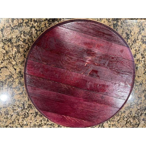 Top view of 12-inch handcrafted rustic barrel lid lazy Susan on a granite counter, displaying rich wooden texture and finish.