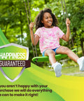 Child enjoying Stand Up Tree Swing For Kids With Adjustable Handles, Surf Style Kick Swing, green board outdoors.