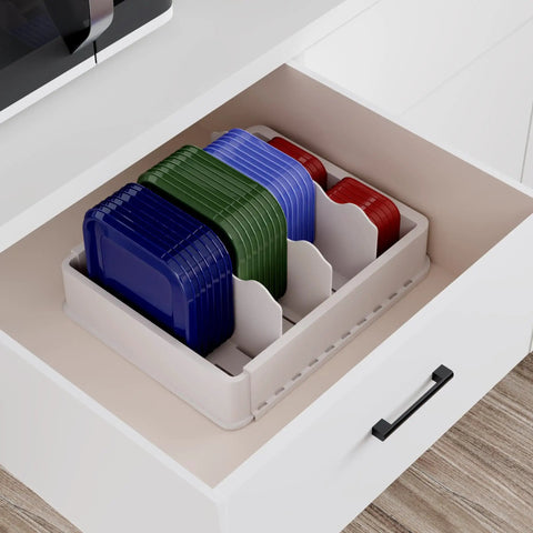 Expandable Food Storage Lid Organizer With Six Adjustable Dividers And 30 Writable Labels Holds Dozens Of Lids From 9.8 To 17.3 Inches Keeps Cabinets Neat And Lids Accessible In White, shown in a drawer with lids inside.