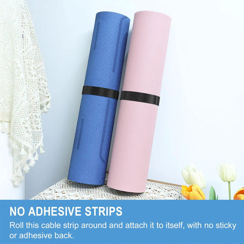 One Inch By Thirty Foot Hook And Loop Tape Roll Featuring Heavy Duty Fabric Straps With Slick Self Adherence Cut To Any Size For No Sweat Cable Wrapping And Garage Gear Management. Two rolls displayed in blue and pink with black straps.