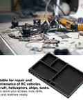 Magnetic RC Parts Tray Portable Aluminum Alloy Repair Tray With Magnetic Screw Holder Plate For Neat Organization During RC Car And Boat Fixes Axial Compatible on a cluttered workbench with RC helicopter parts.