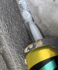 Close-up of Heavy Duty Grey Semi Self Leveling Sealant Two Pack being applied to a crack in concrete surface.