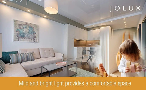 Spacious living room with modern decor and cozy lighting, featuring a child playing with blocks, bright and inviting atmosphere.