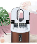 Heavy Hitter Countertop Ice Maker Churning Out Sixteen Kilos Daily With Nine Ice Cubes Ready In Just Thirteen Minutes Auto Self Cleaning Compact Design Includes Scoop And Basket pouring water into machine