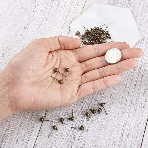 Antique Bronze Round Ball Post Stud Earrings Kit, 100 Pcs Brass Ear Pins With 1mm Loop For Jewelry Making, Vintage Style DIY Jewelry Supplies, 14.5mm Length, 12mm Width, 1.2mm Hole, in hand with coin