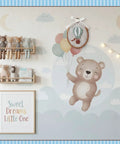 Vintage Hot Air Balloon Wall Art For Nursery And Kids Rooms hanging on wall with teddy bear and colorful balloons, felt centerpiece displayed.