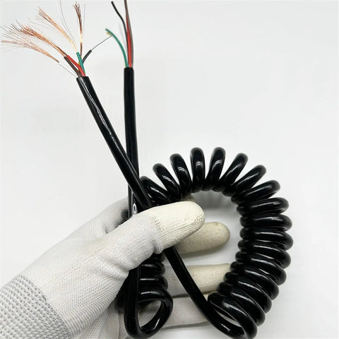 Slick Black Braided Expandable Power Cord With Coiled Spring Design, showing hand holding coiled cable with exposed wires.