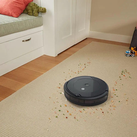 Must Have Replacement Parts Kit For Roomba 600 Series Robots With AeroVac Filters in use on carpet with scattered debris