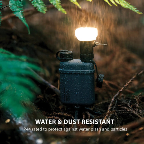Go-To Rugged Outdoor Camping LED Lantern With Mini Tripod in rain showing IP44 weatherproof feature.