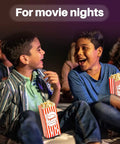 Two boys enjoying popcorn in 100 Disposable Popcorn Bags 1oz Paper Bags For Popcorn And Kernels Mini Containers at a movie night