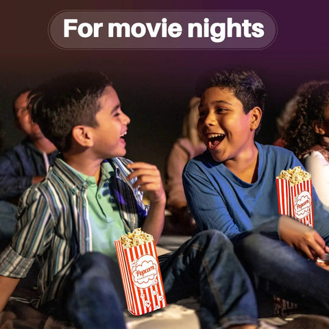 Two boys enjoying popcorn in 100 Disposable Popcorn Bags 1oz Paper Bags For Popcorn And Kernels Mini Containers at a movie night