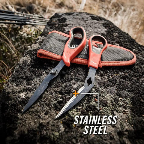 Take-A-Part Poultry And Small Game Shears With Serrated Blades, Pivot Pin Release, Bright Orange Rubber Handle, and belt sheath on rock