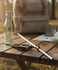 Compact Stainless Steel Multitool With Folding Screwdriver And Bottle Opener for pocket carry on outdoor wooden table.