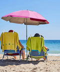 12 Pack Heavy Duty Plastic Clothes Pins Featuring Anti Rust Springs And Non Slip Silicone Pads holding towels on beach chairs under an umbrella.