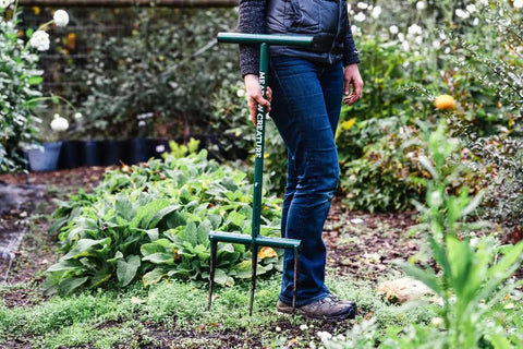 Person using Raised Bed Garden Fork With 9 Inch Tines For Small Plots, Lightweight Metal Broadfork, in a garden setting.