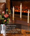 Flameless Taper Candles With Remote And Timer 6 Pack LED Battery Operated Flickering Ivory Candlesticks on table with flowers