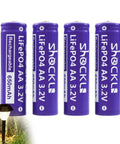 4 Pack AA 3.2V LiFePo4 650mAh Solar Rechargeable Batteries for Garden Lights with LiFePO4 cells next to garden light