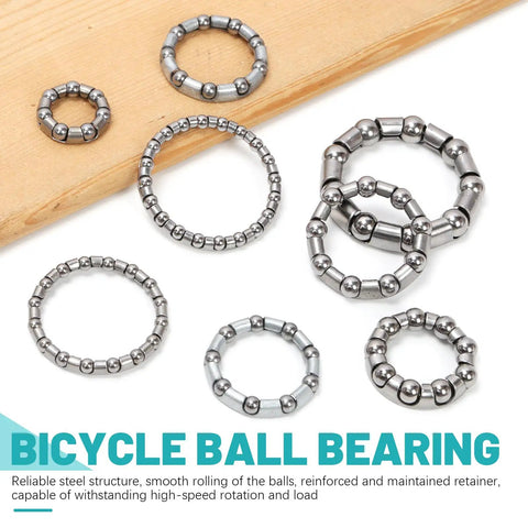 Bike Ball Bearing Kit 50 Pieces In 5 Sets Of 10 Varieties With Retainers And Cage For MTB Crank Bottom Bracket Headset Bearings Replacement Parts For Bicycles Easy Storage Box displayed on wooden surface