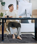 Man sitting at desk on 36 By 48 Inches Tough As Nails Office Chair Mat For Hardwood And Tile Floors, protects floors, smooth glide