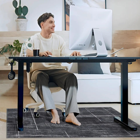 Man sitting at desk on 36 By 48 Inches Tough As Nails Office Chair Mat For Hardwood And Tile Floors, protects floors, smooth glide