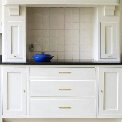 White cabinets with Brushed Brass Cabinet Knobs Set 20 Pack For Modern Kitchen Drawers And Cabinets 1.27 Inch Zinc Alloy Knobs installed.