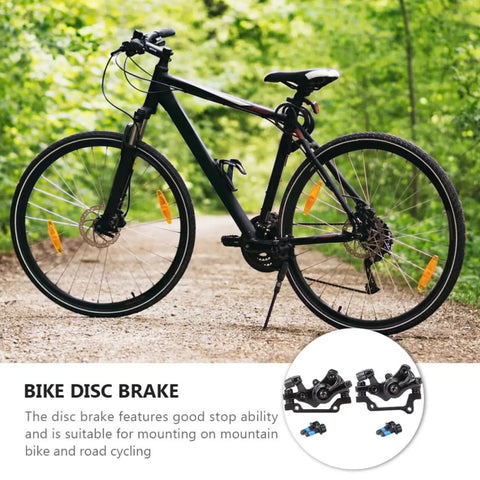 Heavy Duty Pair Of Mechanical Disc Brakes For Mountain And Road Bikes Aluminum Caliper on a black bike in a green trail.