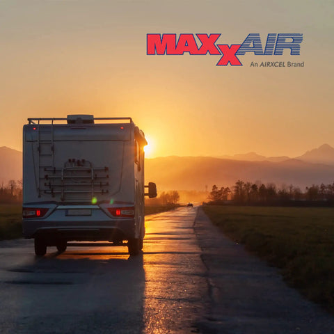 RV driving at sunset with MaxxAir logo visible