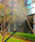 Brass Misting Nozzle Replacement Heads 0.2mm Orifice 10/24 UNC Outdoor Cooling System in action in a garden setting.