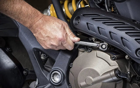Using 12 Point Reversible Ratcheting Combination Wrench 15/16 Inch Slim Profile Box End on motorcycle engine in tight space