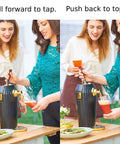 Two women demonstrating the Portable Electric Ultrasonic Foam Maker Craft Beer And Cocktail Dispenser at a gathering.