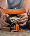 Person using Jetpower Fuel Canisters For Camping Stoves Two Pack 100 Gram Iso Butane Propane Mix For Backpacking on a stove