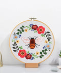 All In One Bee Embroidery Kit For Beginners With Hoop And Thread, showing a completed bee and floral pattern in wooden hoop
