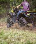 Beefy 28 Inch ATV UTV Disc Plow Harrow with Universal 2 Inch Receiver Mount in action, plowing through a grassy field.