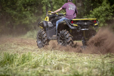 Beefy 28 Inch ATV UTV Disc Plow Harrow with Universal 2 Inch Receiver Mount in action, plowing through a grassy field.