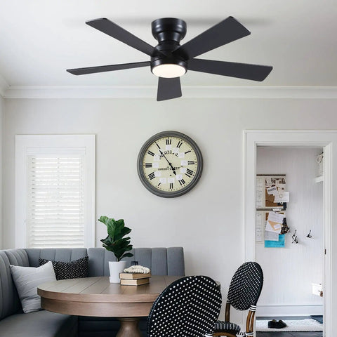Sleek 46 Inch Flush Mount Ceiling Fan With Integrated Light Kit And Wireless Remote, Five Reversible Matte Black Blades in cozy dining area.